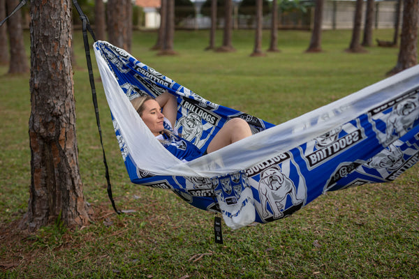 Blue and white Bulldogs NRL recycled hammock with straps, suspended between trees in outdoor setting
