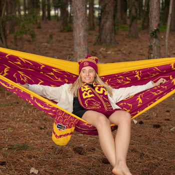 Woman laying back on a Broncos Hammock in the woods