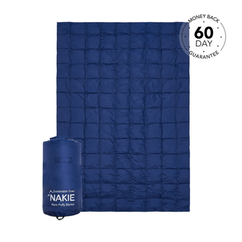 Studio shot of Nakie's Deep Ocean Blue puffy blanket, showcasing its cozy warmth and eco-friendly design, perfect for outdoor adventures and cozy nights.