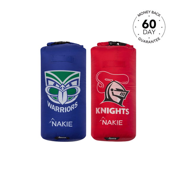 Two puffy down blankets in blue Warriors and red Knights NRL team designs, rolled with black straps and Nakie branding