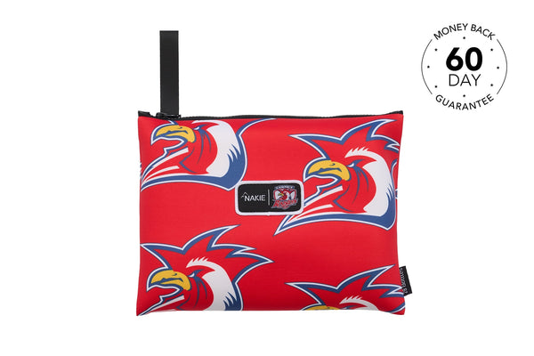 Red recycled beach towel with blue and white rooster pattern, black carry strap, Nakie and Roosters branding label